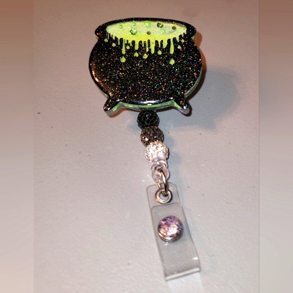 Cauldron liquid shaker badge reel